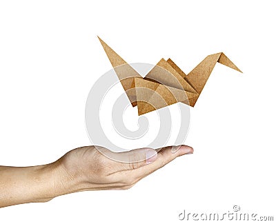 Origami Bird flying from human hand Stock Photo