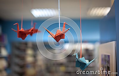 Origami birds hanging on ropes Stock Photo