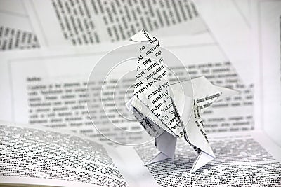 Origami dinosaur coming out of a book Stock Photo