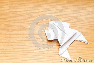 Origami frog on wood table Stock Photo