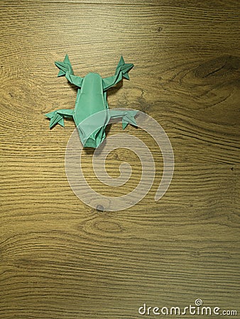 Origami Frog on wooden background Stock Photo