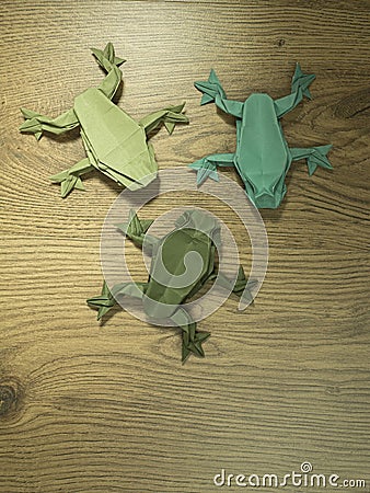 Origami Frogs on wooden background Stock Photo