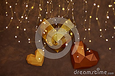 Origami paper hearts geometric on the brown wall with garland Stock Photo