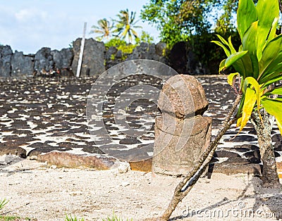 Original ancient stone carved tiki (Polynesian sacred idol statue), Marae Taputapuatea, Raiatea, French Polynesia. Stock Photo