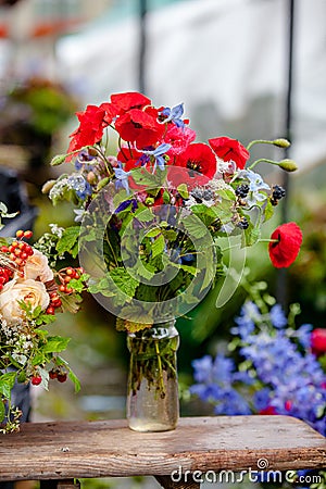 Original bouquet of poppies and blackberries. Stock Photo