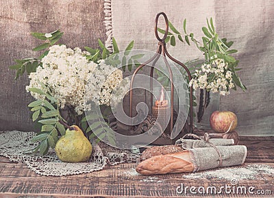 An original still life of Russia with the fire of a wax candle. Candle flame close-up. Country still life with rustic bread, candl Stock Photo