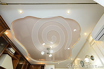 Original stylish multi-level stretch ceiling in the interior of a rich kitchen Stock Photo