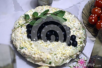 Original vegetable salad with mayonnaise, greens and olives. Stock Photo