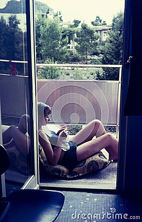 Original vintage colour slide from 1960s, young woman relaxing a Stock Photo