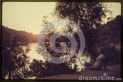 Original vintage colour slide from 1960s, young woman sitting by Stock Photo