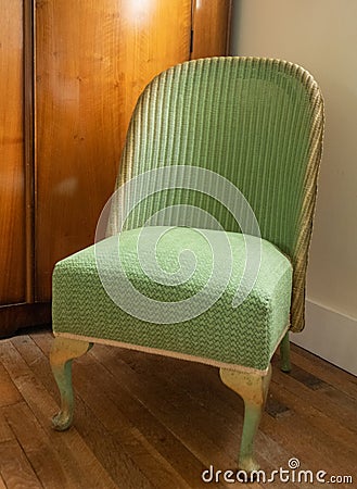 Original vintage deco green Lloyd Loom wicker rattan chair from the 1930s. Stock Photo
