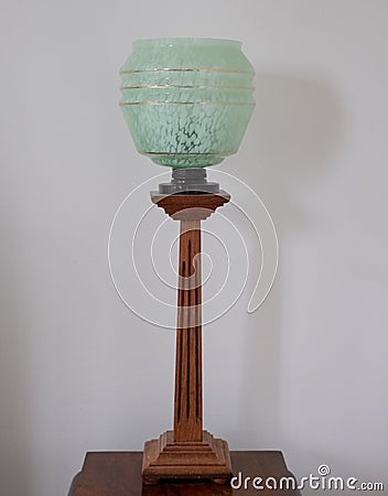 Original vintage deco green glass and wood lamp dating to the 1930s. Stock Photo