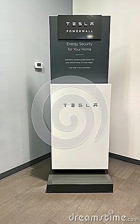 The Tesla Powerwall and Sign at the entrance of the Tesla dealership in Orlando, FL Editorial Stock Photo