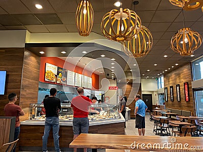 People waiting in line at a Panda Exress restaurant to order Chinese food Editorial Stock Photo