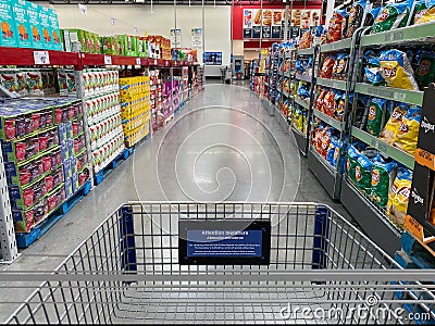 The snack aisle of a Sams Club Wholesale grocery store with a variety of chips and fruit snacks ready to be purchased by consumers Editorial Stock Photo