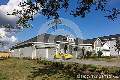 A residential home with an expensive Porsche Spyder in the driveway Editorial Stock Photo