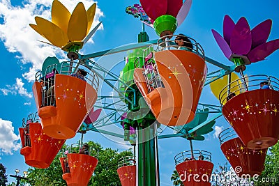 Parents and kids enjoying colorful flower pots aboard Abbyâ€™s Flower Tower at Seaworld in International Drive area 1 Editorial Stock Photo