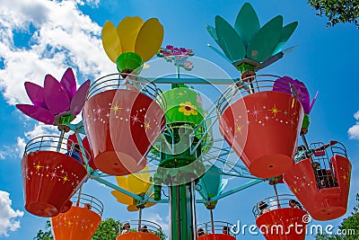 Parents and kids enjoying colorful flower pots aboard Abbyâ€™s Flower Tower at Seaworld in International Drive area 2 Editorial Stock Photo