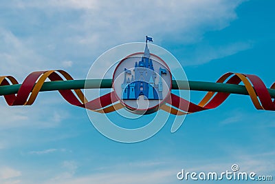 Top view of Cinderella`s Castle sign on lightblue cloudy sky background at Walt Disney World area. Editorial Stock Photo