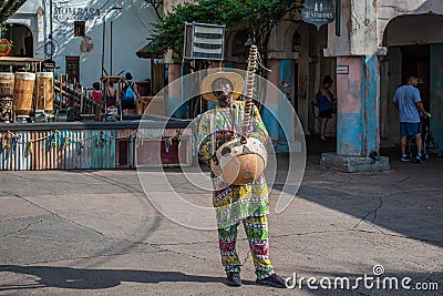 African musician playing typical string instrument at Animal Kingdom 1 Editorial Stock Photo
