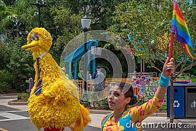 Big Bird and woman dancer with colorful flag at Seaworld Editorial Stock Photo