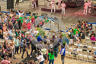 Alexander Delgado, his son and Randy Malcom by Gente de Zona walk among the audience, to the stage at Seaworld in International D Editorial Stock Photo