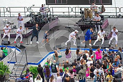 Alexander Delgado, his son and Randy Malcom sing and dance with the band by Gente de Zona at Seaworld in International Drive Area Editorial Stock Photo