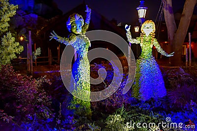 Frozen Elsa and Ana illuminated topiaries on beautiful scenery at Epcot in Walt Disney World Editorial Stock Photo