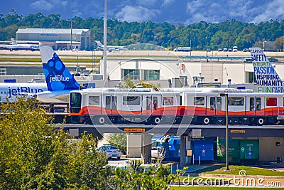 Roll-onroll-off train and partial view of aircraft at Orlando International Airport 2 Editorial Stock Photo