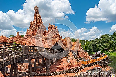 People enjoying amazing Big Thunder Mountain Railroad on cloudy sky background in Magic Kingdom at Walt Disney World 17 Editorial Stock Photo