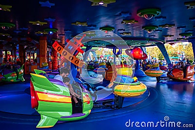 People enjoying Alien Swirling Saucers at Hollywood Studios 100 Editorial Stock Photo