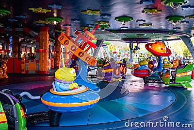 People enjoying Alien Swirling Saucers at Hollywood Studios 103. Editorial Stock Photo