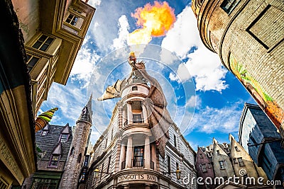 Orlando, USA - Feb. 12, 2021: Fire breathing dragon on top of Gringotts bank Editorial Stock Photo