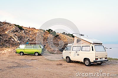 Ormos Panagias, Greece, 28/06/2019: Classical vintage recreational vehicles parked on the beach by the sea. Camper lifestyle Editorial Stock Photo