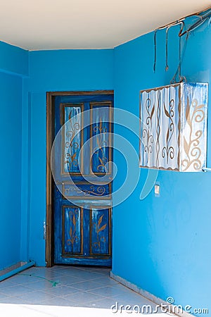 Ornament with curls on blue door Stock Photo