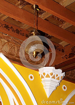 An ornamental wood ceiling with classical lamp in the palace of bangalore. Stock Photo