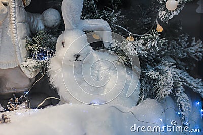 gifts under the tree. White rabbit figure Stock Photo