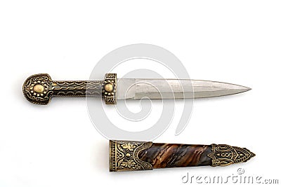 Ornate ceremonial dagger next to a jeweled scabbard Stock Photo