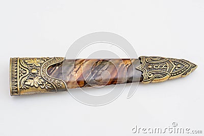 Ornate ceremonial dagger next to a jeweled scabbard Stock Photo