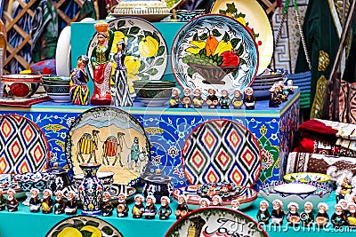 Ornate colorful oriental dishes and ceramics on market window. Silk Road Stock Photo