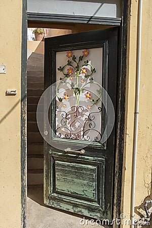 Ornate wrought iron doorway in a back street of Archanes, Crete Editorial Stock Photo