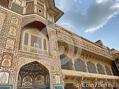 Ornate exterior of Amber Palace against the background of a cloudy sky. Jaipur, India. Stock Photo