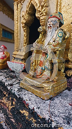 Ornate golden statue of Confucius in a traditional Khmer shrine in the town of Kampot, Cambodia Editorial Stock Photo