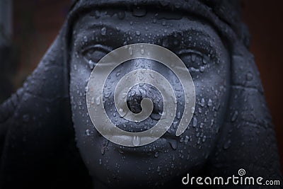 Ornate hand made Cleopatra statue with rain drops Stock Photo