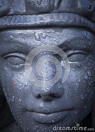 Ornate hand made Cleopatra statue with rain drops Stock Photo