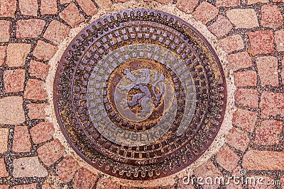 Ornate manhole cover with the Czech and Bohemian coat of arms wi Stock Photo