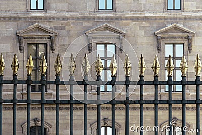 An ornate metal fence with gold-tipped spearhead finials Stock Photo