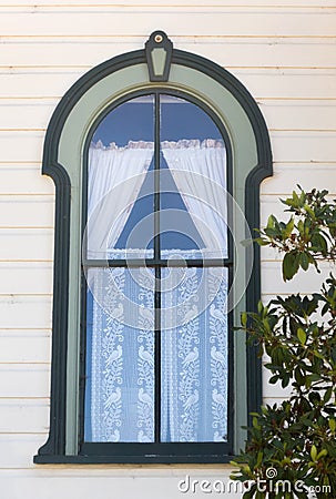 Ornate old window, lace curtains Stock Photo