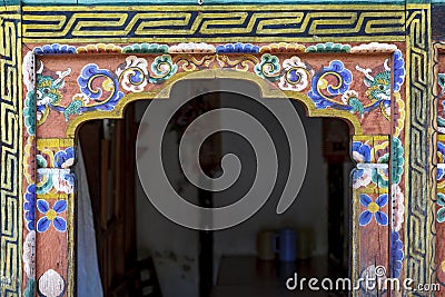 Ornate painted and decorated doorpost with dragons an flowers in Bhutanese style, Mongar, Bhutan Stock Photo