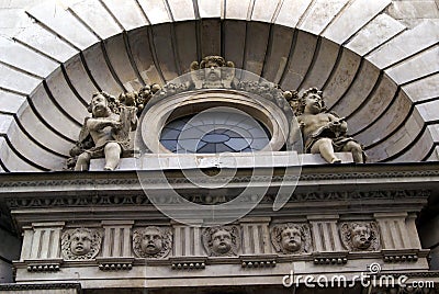 Ornate sculptured facade with an arch and angels Stock Photo